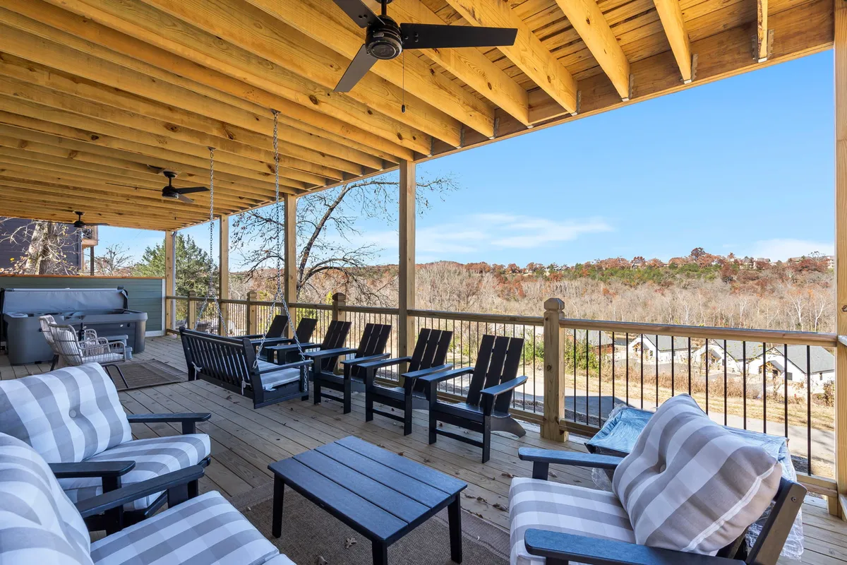 A tranquil wooden deck with comfortable seating overlooks a lush landscape, perfectly positioned for enjoying sunsets, social gatherings, or a peaceful moment with a book. The inviting ambiance encourages guests to embrace the outdoor lifestyle.